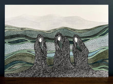 Load image into Gallery viewer, Macbeth Weird Sisters on the moorland image in black frame with blue wall background, standing on a wooden surface.