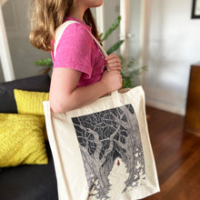 Load image into Gallery viewer, Red Riding Hood canvas tote bag being carried over the shoulder by a girl wearing a pink t-shirt in a living room with a wooden floor.