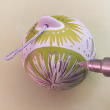 Load image into Gallery viewer, Handpainted ceramic Christmas bauble with pattern in lilac and green acrylic paint pen

