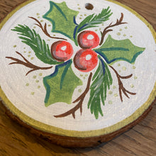 Load image into Gallery viewer, Handpainted wood slice Christmas ornament with holly leaf and berry design and a gold edging
