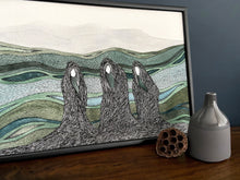 Load image into Gallery viewer, Macbeth Weird Sisters on the moorland image in black frame with blue wall background, standing on a wooden surface. Dried seedhead and vase stands next to it.

