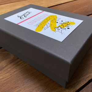 Doodler's Art Set grey gift box with label on wooden background.